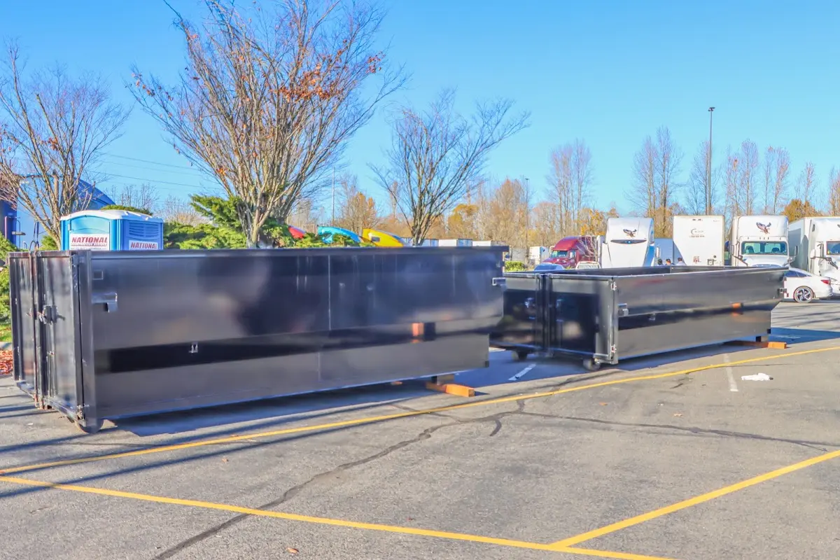 Professional dumpster rental service with roll-off container on residential driveway in Lake St. Louis